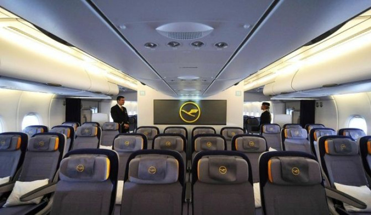 Flight attendants stand in aisle of the Economy Class in new Airbus A380 aircraft for Lufthansa.