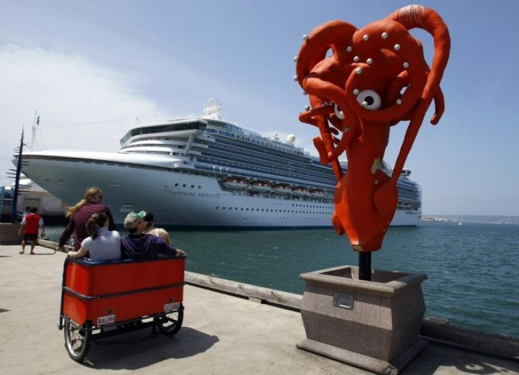 Tourists are given a ride past a sculpture as the Sapphire Princess sits at dock in San Diego Harbor