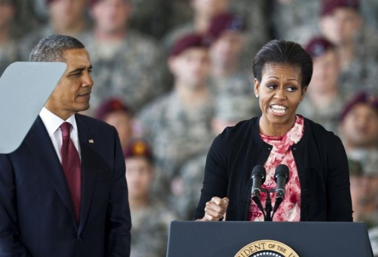 First lady Michelle Obama speaks to troops as her husband and U.S. President Barack Obama looks on at Fort Bragg in Fayetteville.