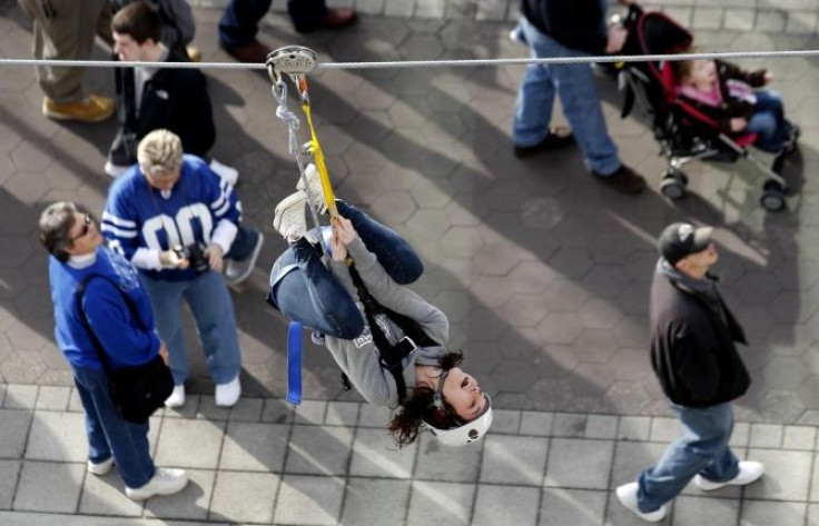 A fan rides on a zip line in downtown Indianapolis, Indiana, February 3, 2012, the day the measles-infected patient was in the Superbowl village.