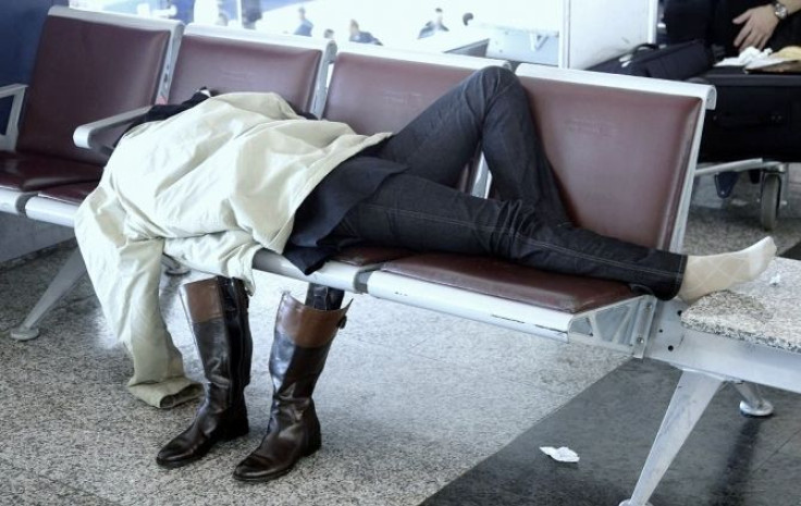 A passenger sleeps on a bench at the Fiumicino International airport in Rome November 11, 2008.