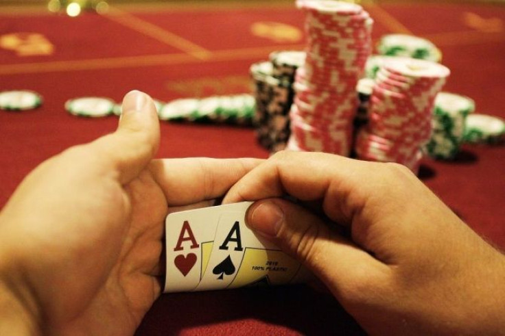 A player checks his cards during the finals of the Russian Masters Poker Cup in the casino at the Azov-City gambling zone