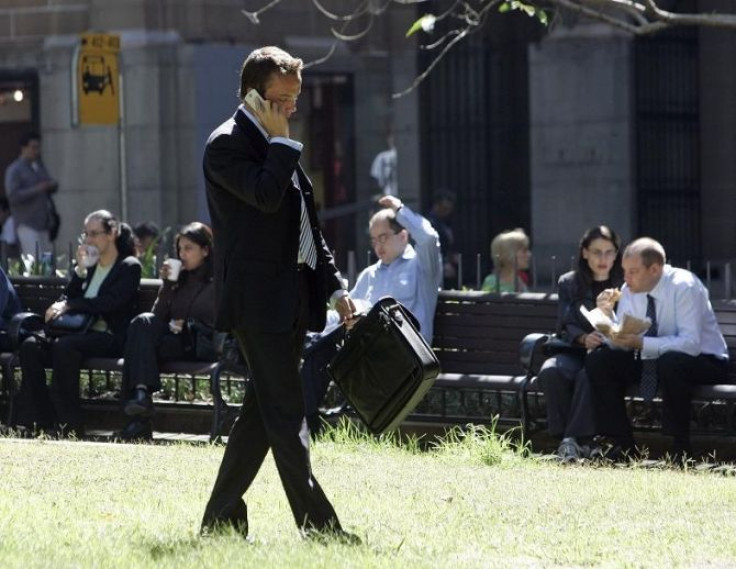 A businessman walks and talks on his mobile phone.