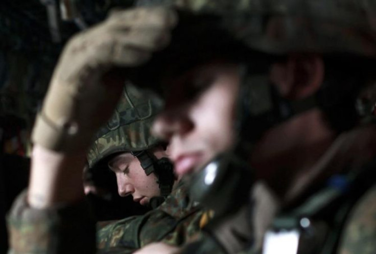 Soldiers of the 1st German paratroop battalion 331 sit onboard an Air Force C-130J transport plane for a training flight at the air base in Ramstein February 23, 2012.