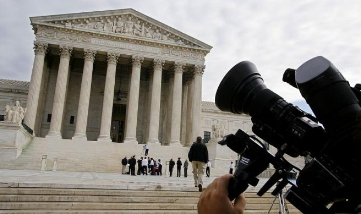 A television camera is pointed at the facade of the Supreme Court.