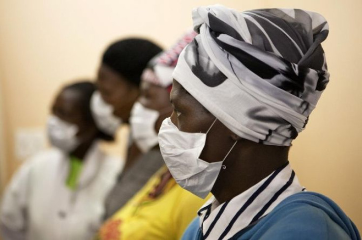Patients with HIV and tuberculosis (TB) wear masks while awaiting consultation at a clinic in Cape Town's Khayelitsha township, in South Africa February 23, 2010.