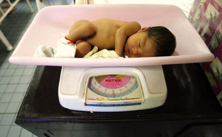 A baby lies on the scale of a weighing machine inside the maternity ward of the government run Dr. Jose Fabella Memorial Hospital in Manila June 1, 2011.