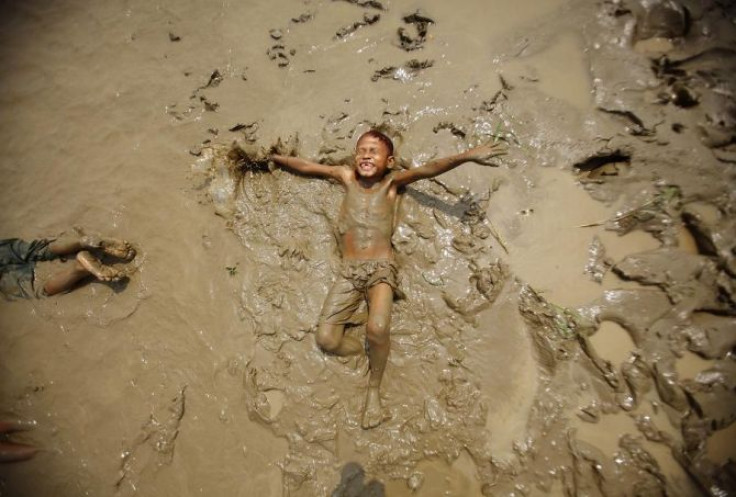 A boy plays in the mud on the bank of the Bago river in Bago March 20, 2012.