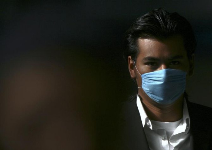 A man wears a surgical face mask as he walks to the Metro station in Mexico City April 27, 2009.