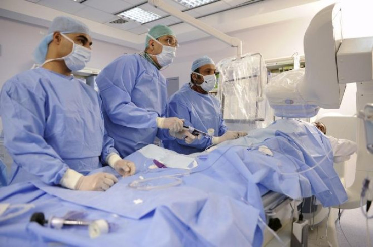 Kuwaiti Interventional Cardiologist Dr Ibrahim Al-Rashdan (R) performs a PCI (Percutaneous Coronary Intervention) stent implantation surgery