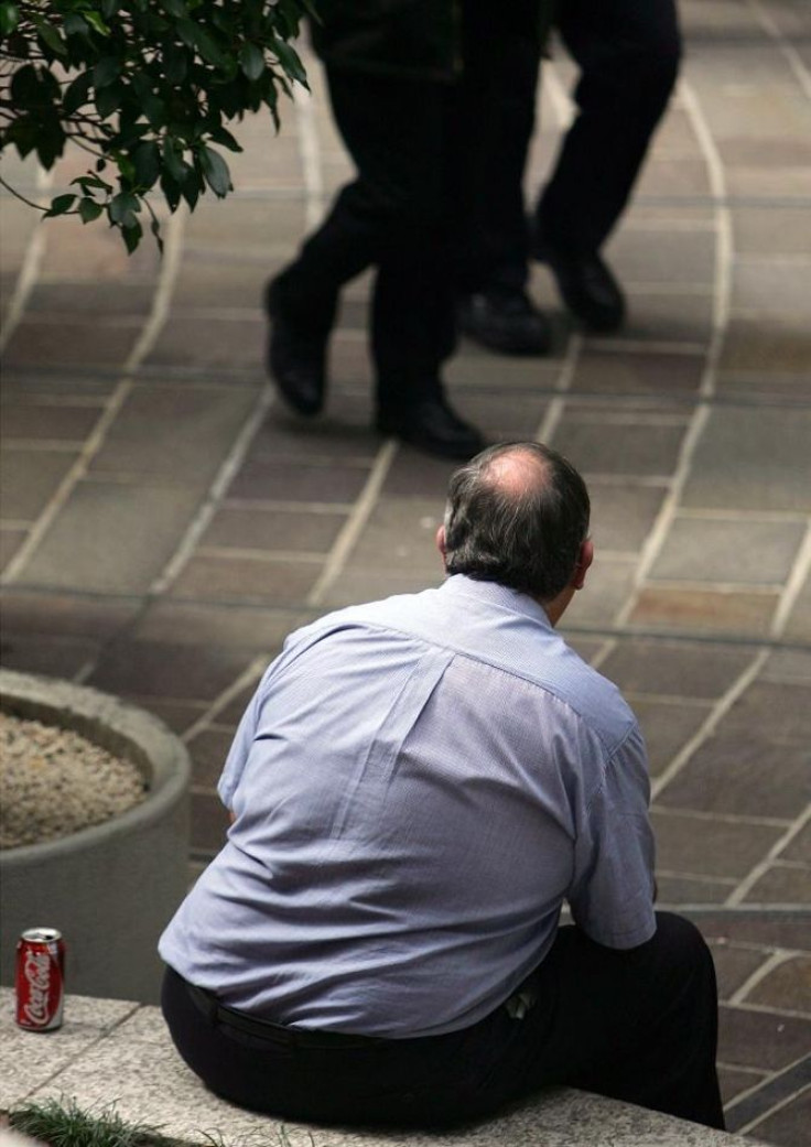 A man rests at lunchtime at an outdoor cafe in Sydney September 6, 2005.