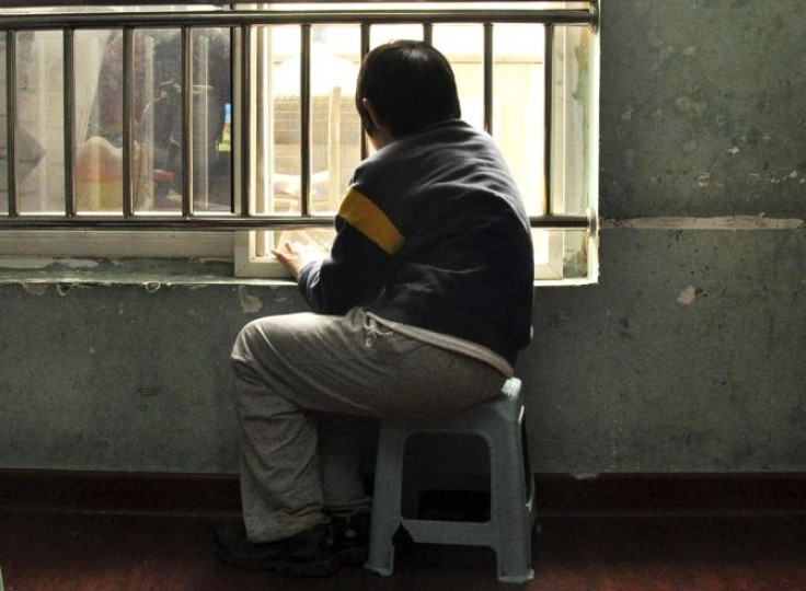 An autistic child looks out of the window at a school for autistic children in Tianjin municipality March 31, 2010.