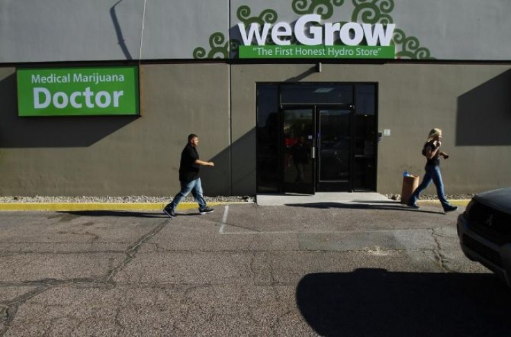 People walk outside the weGrow superstore-sized garden center that sells marijuana products in Phoenix, Arizona June 2, 2011.