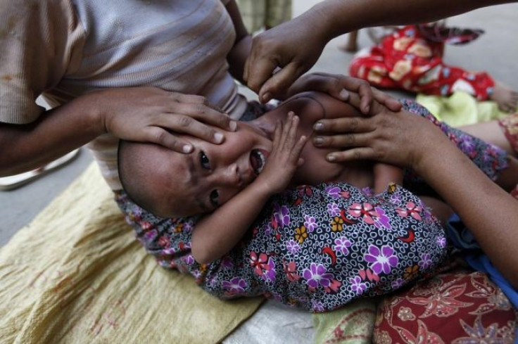 A child suffering from malaria receives a traditional treatment at a camp outside the city of Myitkyina in the northern Myanmar.