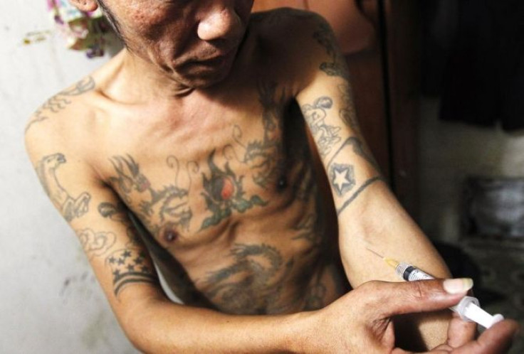 Tuan Anh Nguyen, 45, injects a syringe filled with heroin in his rented room in Hanoi November 23, 2011. Tuan Anh began abusing drugs 23 years ago after being released from prison. He has since spent most of his life in prisons and rehabilitation centres.