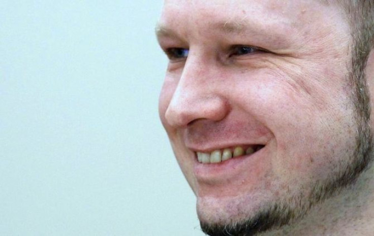 Norwegian mass killer Anders Behring Breivik smiles as he arrives in court for the second day of his terrorism and murder trial in Oslo April 17, 2012.