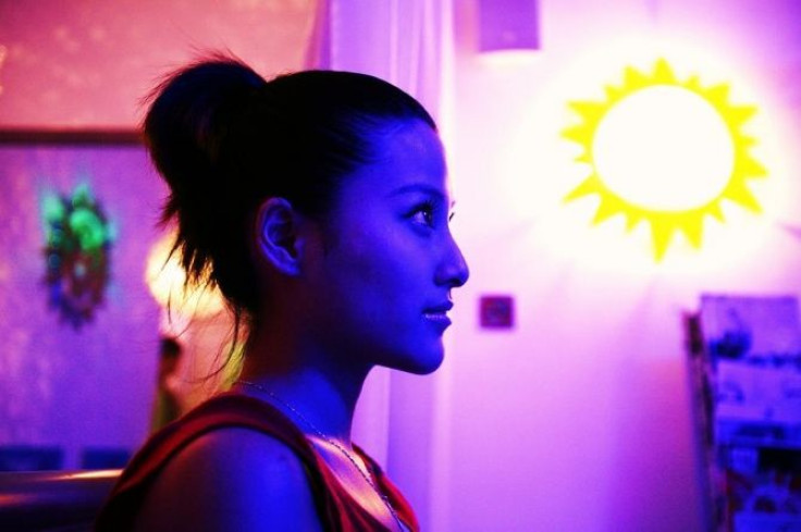 A customer waits to start her tanning session at a tanning salon.