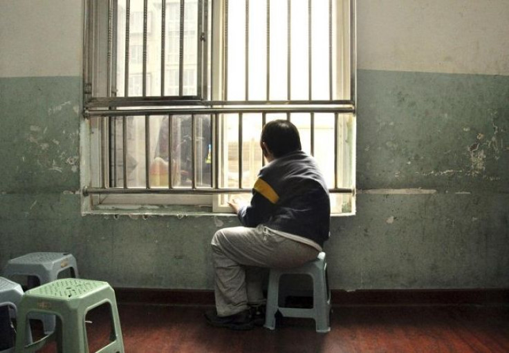 An autistic child looks out of the window at a school for autistic children in Tianjin municipality.