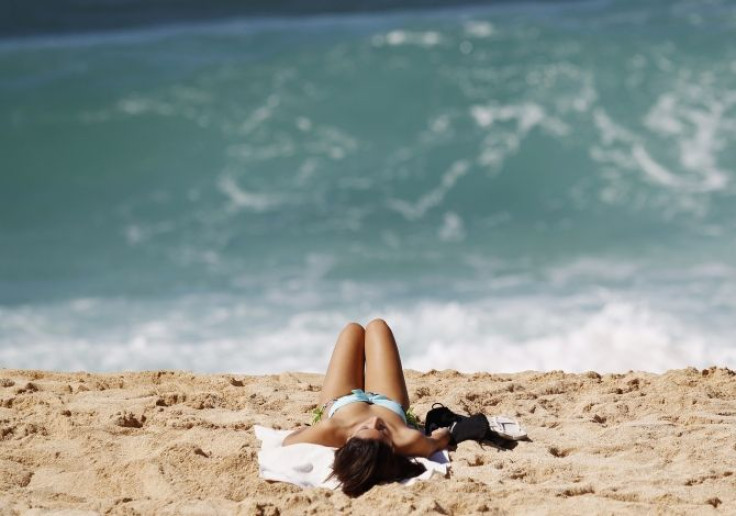 woman sunbathes at beach in Hawaii