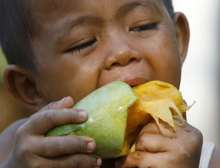 A boy eats a mango in Nakhonsawan province, north of Bangkok