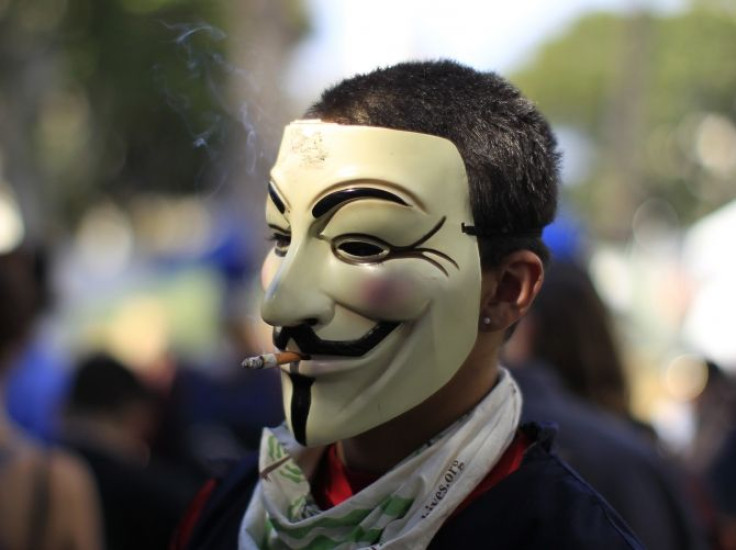 A protester wearing a Guy Fawkes mask, smokes a cigarette during an Occupy LA protest in Los Angeles