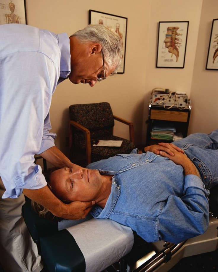 Chiropractor giving an adjustment to a male patient.
