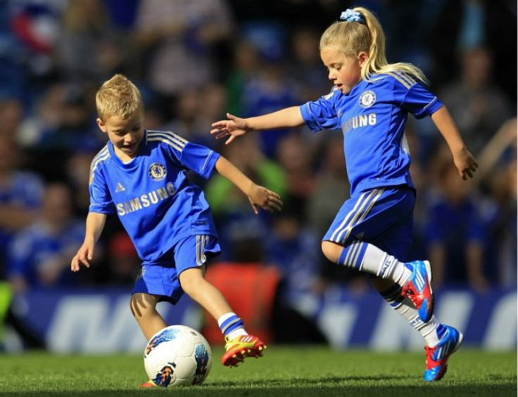 Georgie and Summer, the children of Chelsea's Terry play soccer on the pitch after their English Premier League soccer match against Blackburn Rovers at Stamford Bridge in London