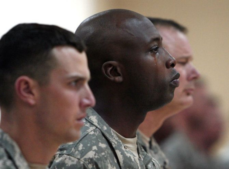 A U.S. soldier sheds a tear during a memorial service for their three fellow soldiers who were killed during clashes in Baghdad.