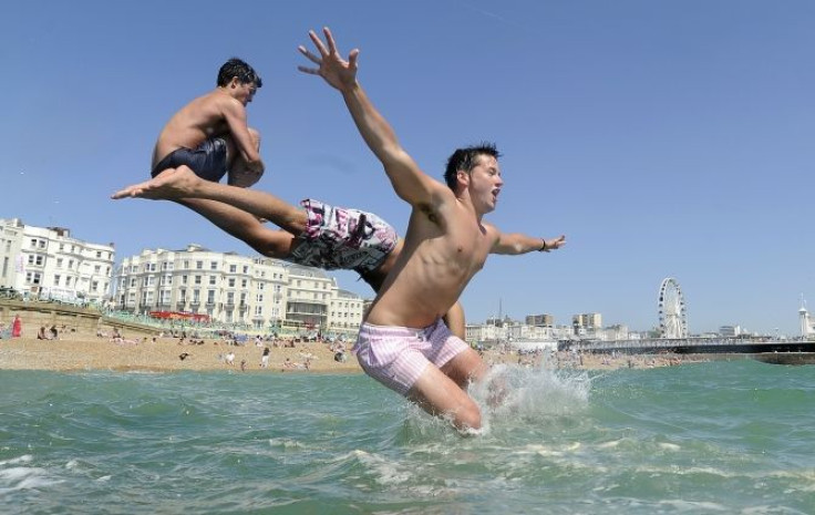 Youths jump into the sea in Brighton