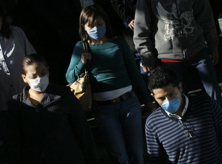Passengers wear protective masks as they enter Chabacano subway station in Mexico City in April 2009