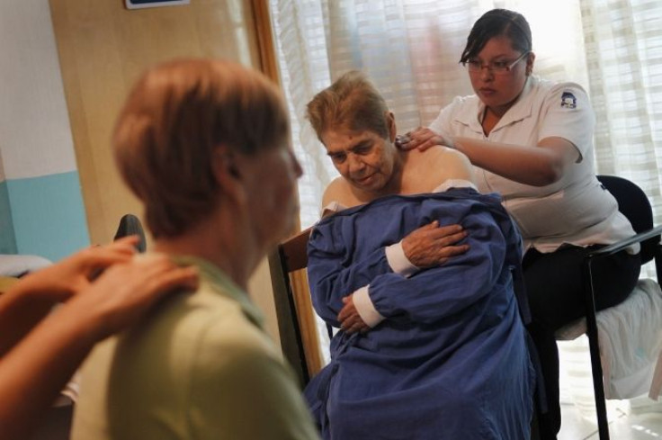 Alzheimer's patients are seen during a massage session inside the Alzheimer foundation in Mexico City April 19, 2012.