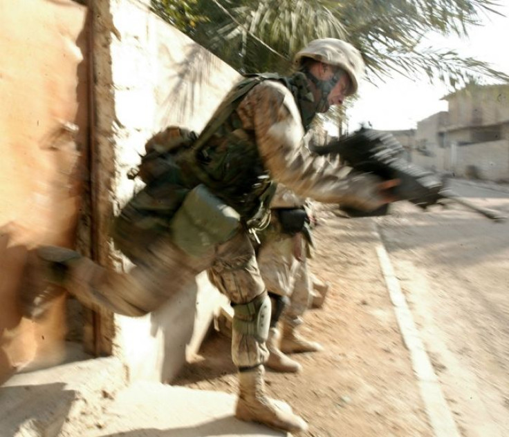 A U.S. Marine with Company, kicks in a door in the war torn Iraqi city of Falluja November 10, 2004. Researchers said that that intentionally preventing sleep in the early aftermath of stress exposure may be effective in reducing traumatic stress because