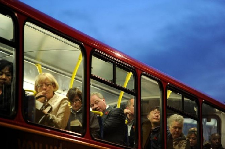 Passengers sit on the top deck of a bus in the City of London, November 10, 2011.