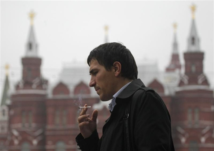 man smokes along a street in central Moscow