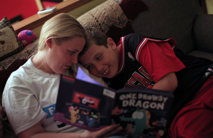 Holly Roos reads to her son Parker, who suffers from autism