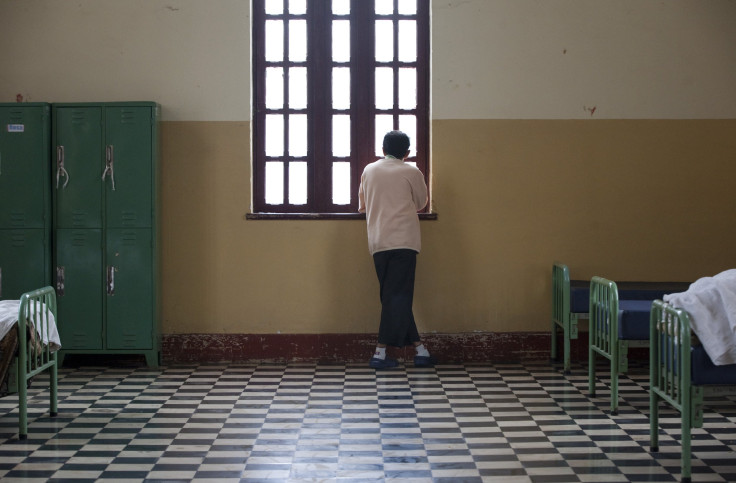 A patient looks through a window inside the Larco Herrera psychiatric hospital in Lima