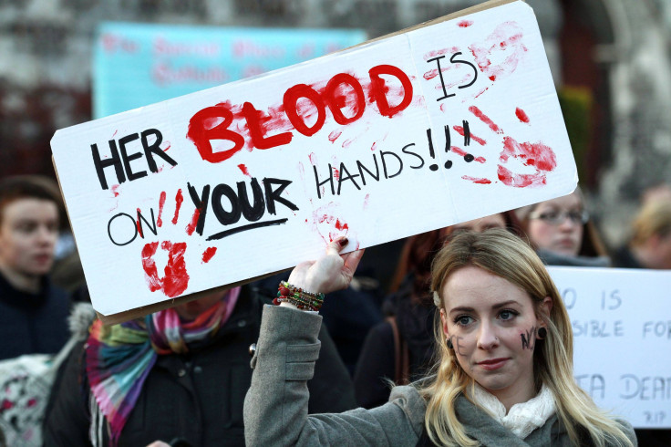 woman holds a poster during a vigil in Dublin November 17, 2012, in memory of Savita Halappanavar