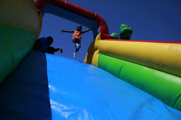 child jumps down an inflatable slide