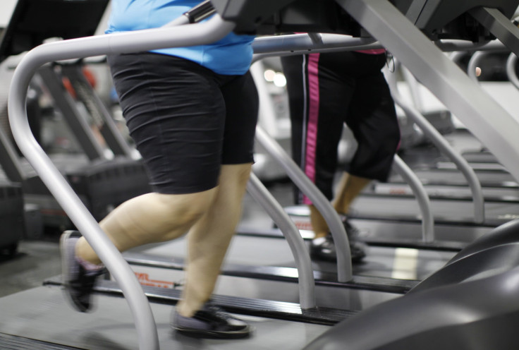 people jog on a treadmill during a workout at a gym