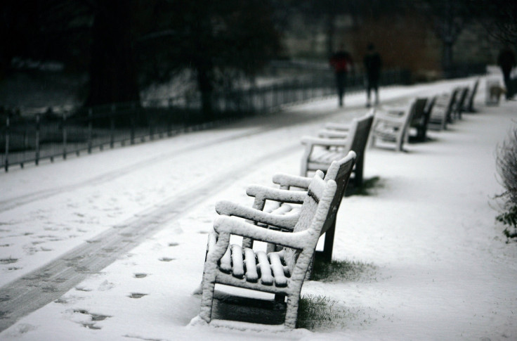 Joggers brave the weather as they make their way through Saint James's park in London