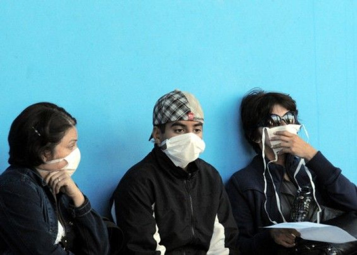 People wearing bird flu precautions