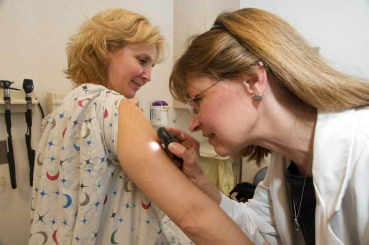 A woman having a skin exam for skin cancer