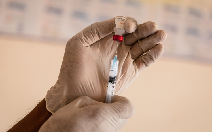 A needle drawing medicine from a storage tube.