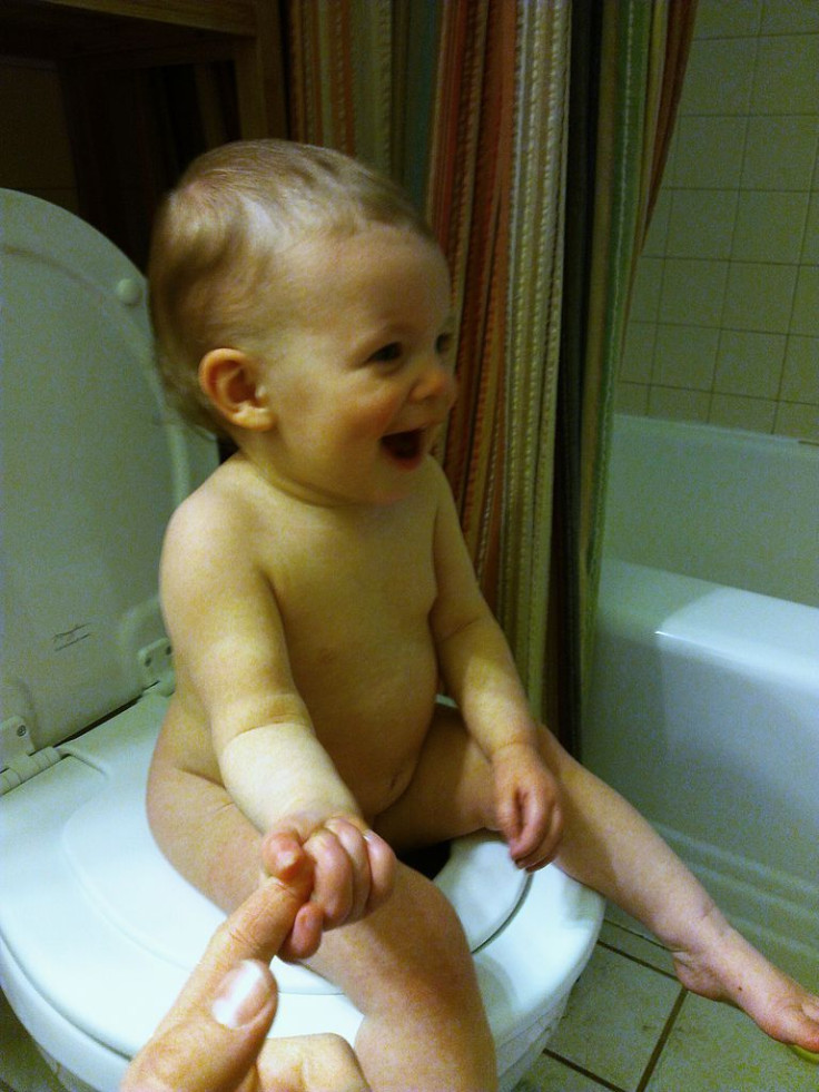 Child sitting on a toilet