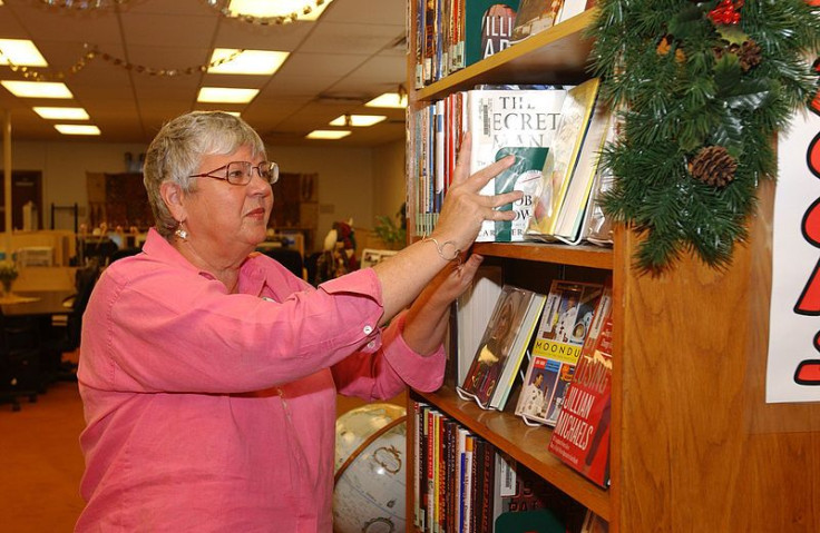 Librarian stocking books