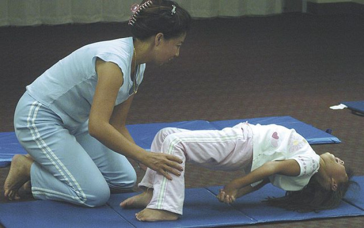 yoga being taught to a child