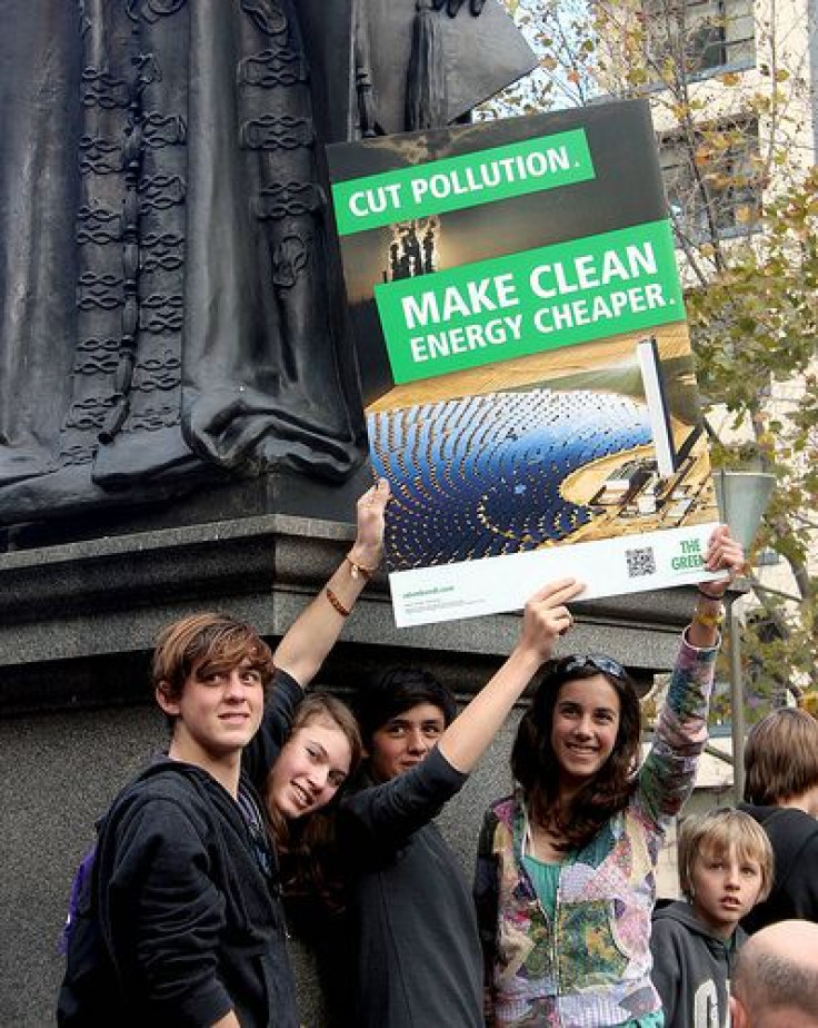 Teenagers holding sign: Make clean energy cheaper - Melbourne World Environment Day 2011
