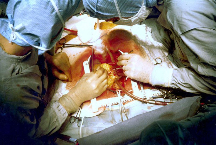 A photo of doctors operating on a pateitn.
