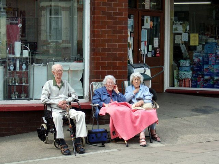 Seniors sitting in front of store