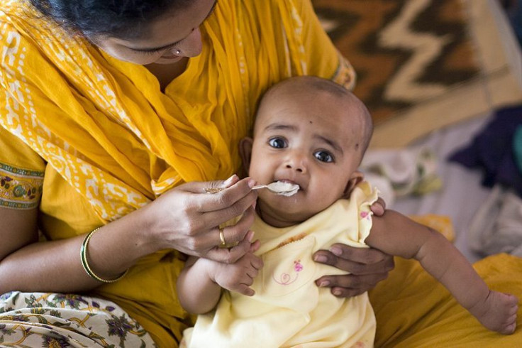 Baby being fed rice for the first time